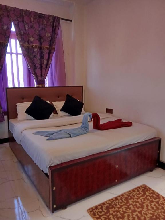 a bedroom with two beds with a stuffed animal on them at The nest haputale in Haputalegama