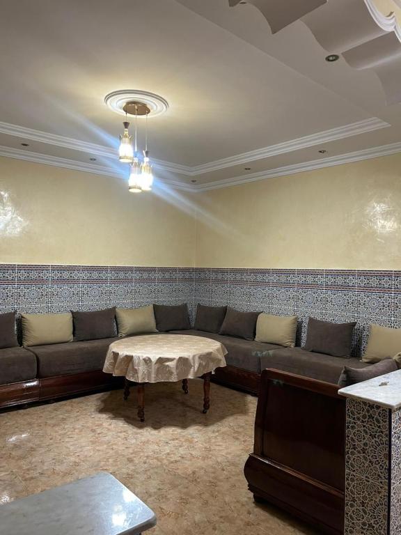 a living room with a couch and a table at Maison in Berkane