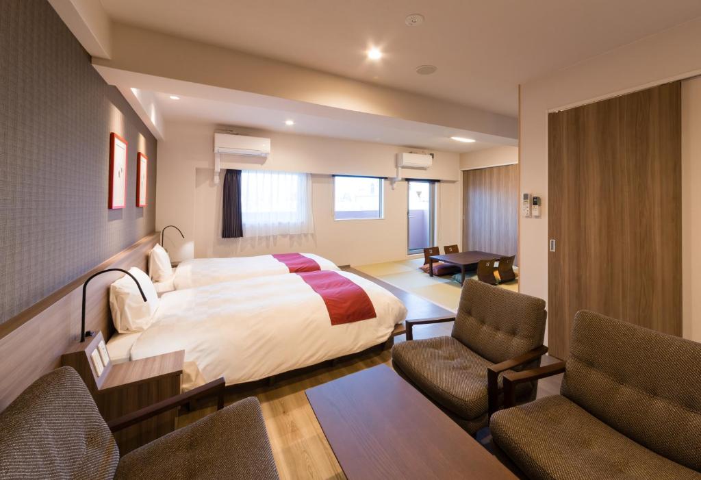 Postel nebo postele na pokoji v ubytování SARASA HOTEL Namba