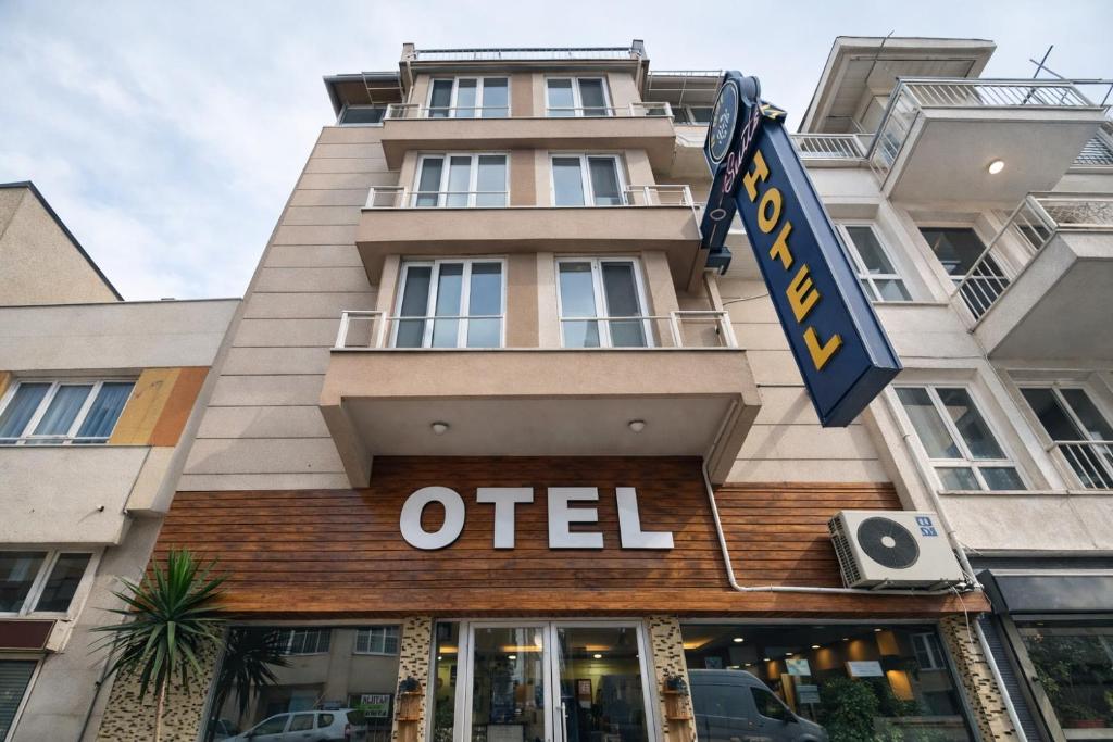 a hotel with an old sign on the front of a building at NEZİH SUİTS OTEL in Antalya