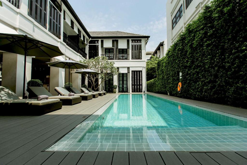a swimming pool in the middle of a building at 99 The Heritage Hotel-SHA Extra Plus Certified in Chiang Mai