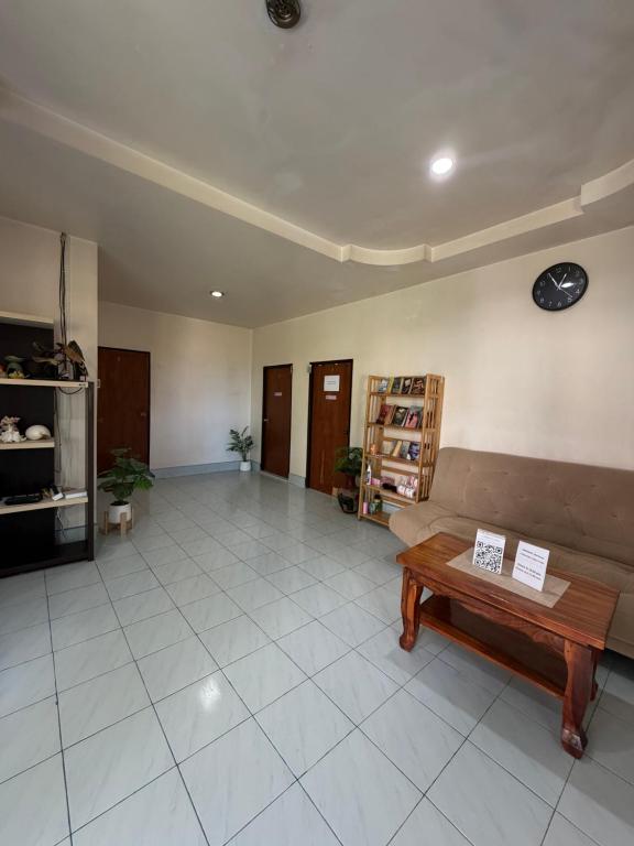 a living room with a couch and a table at Secret Lanta Guesthouse in Ko Lanta