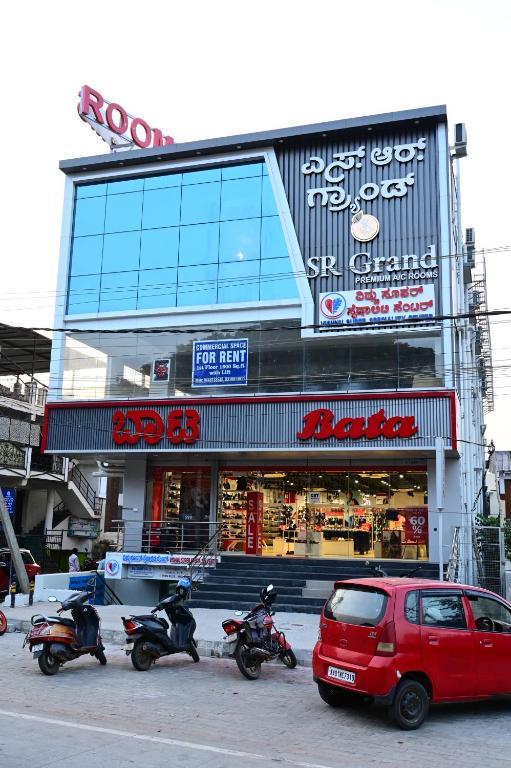 a group of motorcycles parked in front of a building at SR Grand in Tumkūr