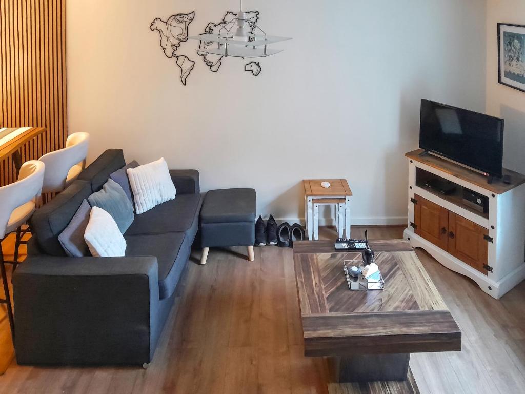 a living room with a couch and a tv at Mountain View in Blaenau-Ffestiniog