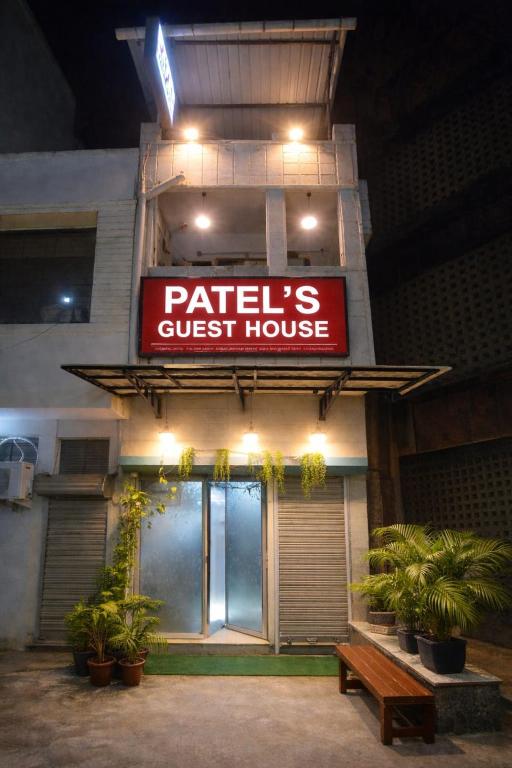 a restaurant with a sign for a guest house at Patel's Guest House in Surat