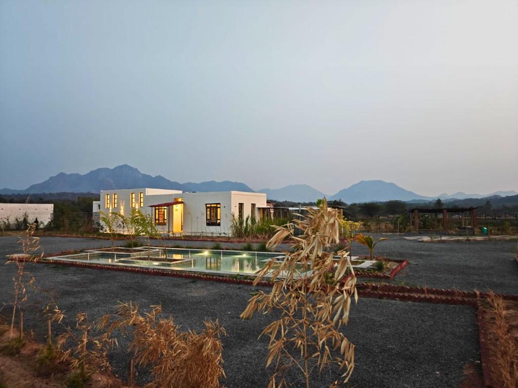 a house with a pool in the middle of a yard at Vanthra Vilas, Jawai - Luxury Villas with Private Pools in Bijāpur