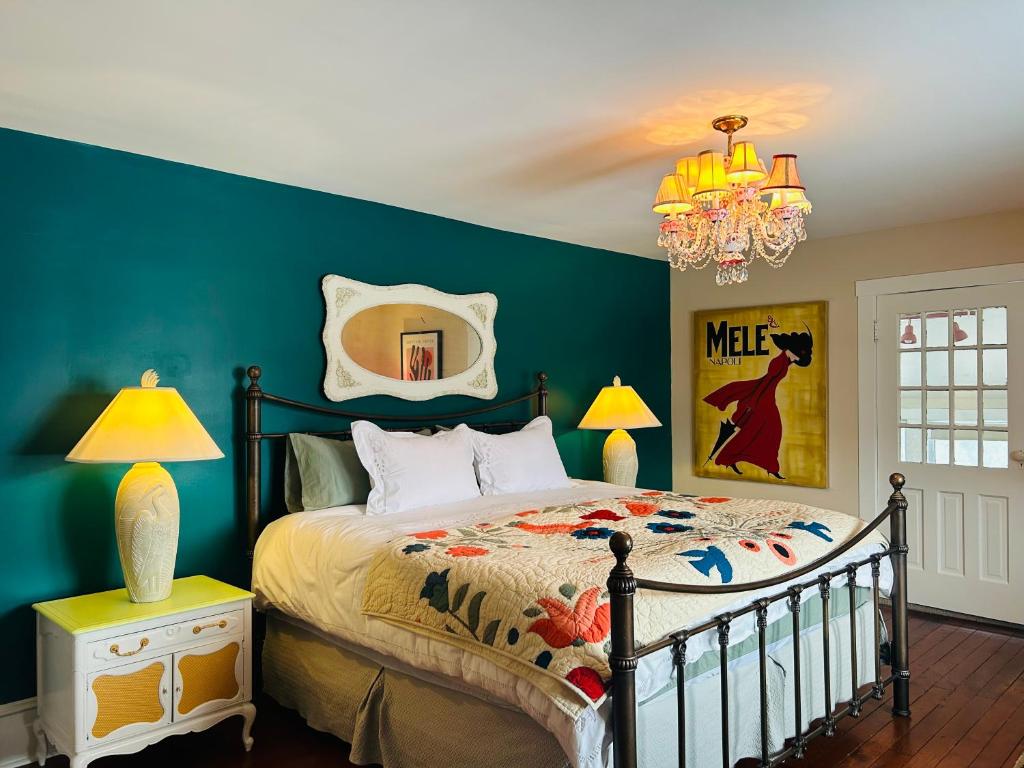 a bedroom with a bed and a green wall at The Farmhouse Manor B&B in St. Catharines