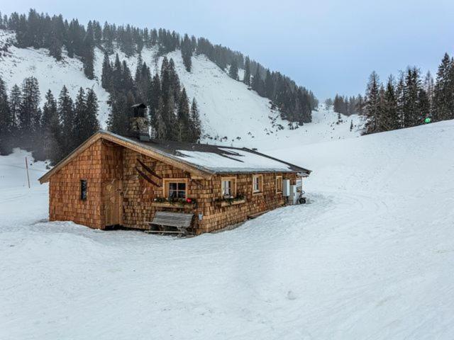 a log cabin in the snow on a mountain at Almhütte Bairau Kaser in Lofer