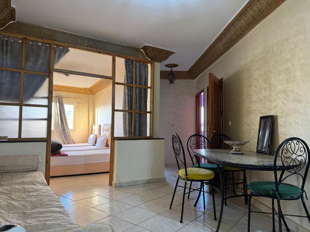 a living room with a table and chairs and a couch at Dar Bennis 2 in Rabat