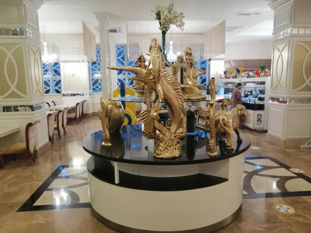 a room filled with gold statues on a table at Апартаменты в Поляне in Polyana