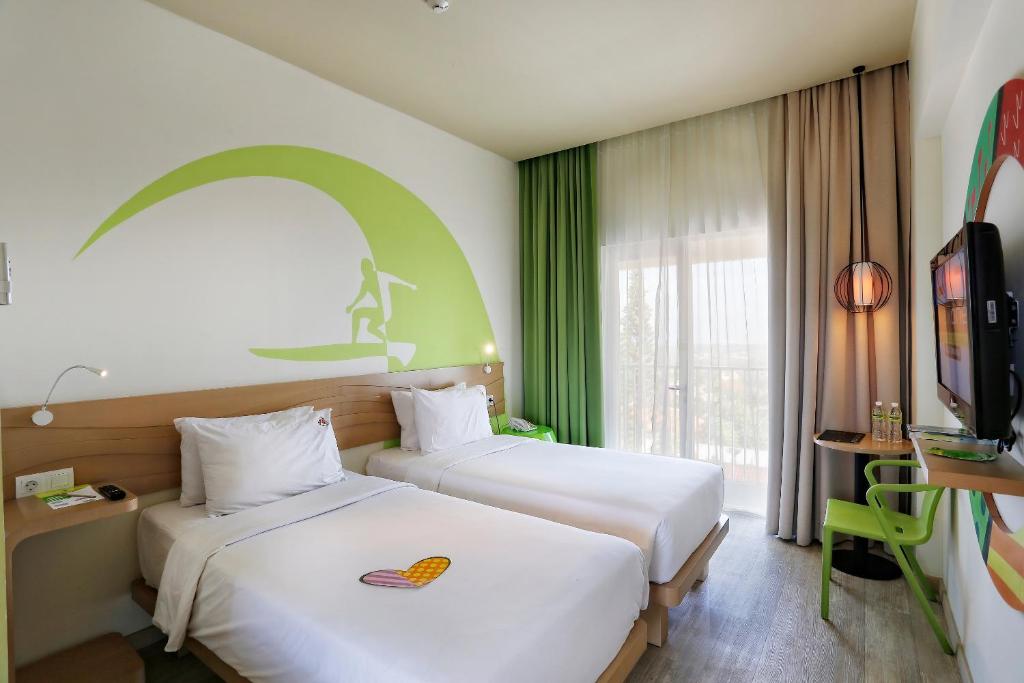 Postel nebo postele na pokoji v ubytování MaxOneHotels at Bukit Jimbaran