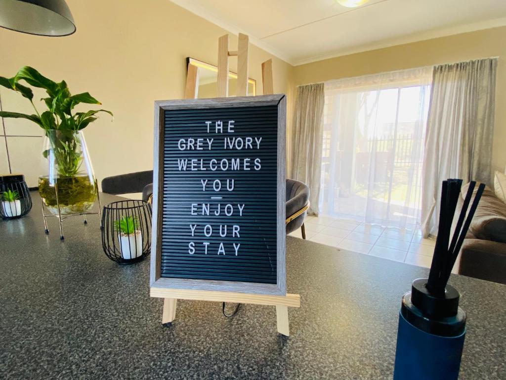 a sign that says the grey way welcomes you enjoy your stay at The Grey Ivory in Port Alfred