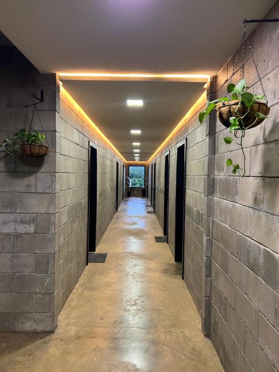 a hallway of a building with lights on the walls at Kazuo520 - Conforto e Minimalismo in Londrina