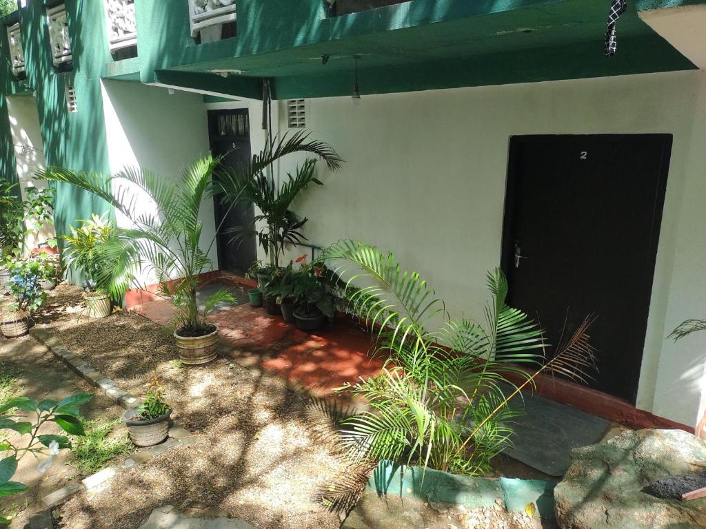 a courtyard with plants in front of a building at Great Resort in Nikawatawana