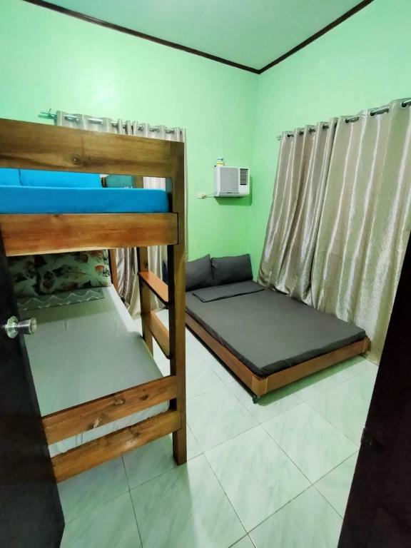 a room with two bunk beds and a microwave at Urban Serenity Home in Puerto Princesa City