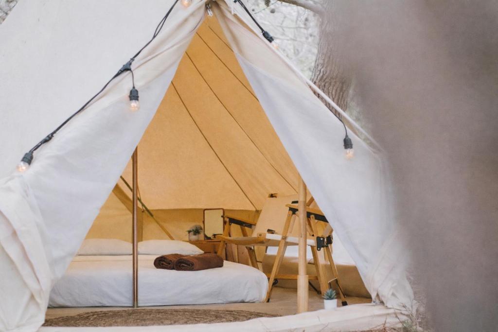 a canvas tent with a bed in a room at Secret View Glamp - La Mariposa in Alghero