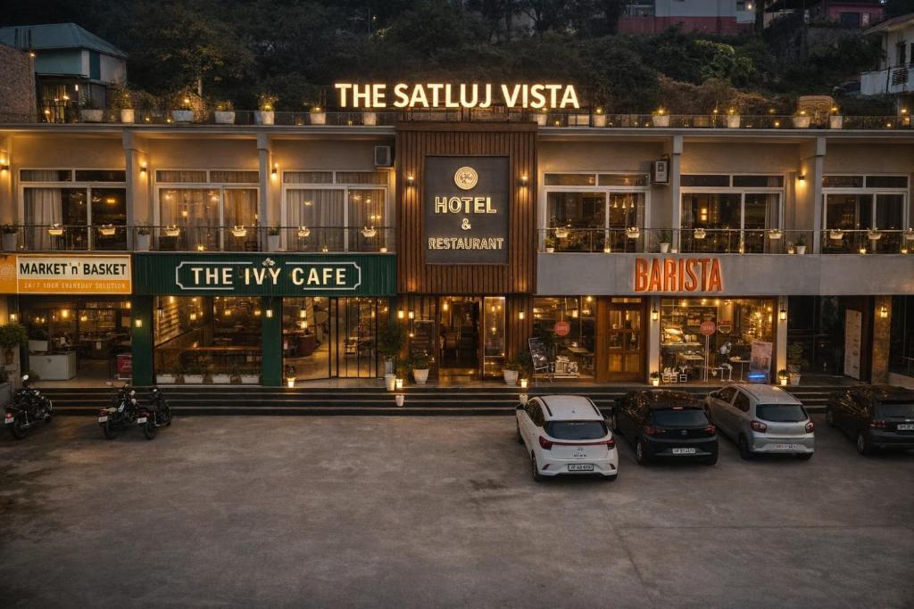 a building with cars parked in a parking lot at The Satluj Vista in Bilāspur