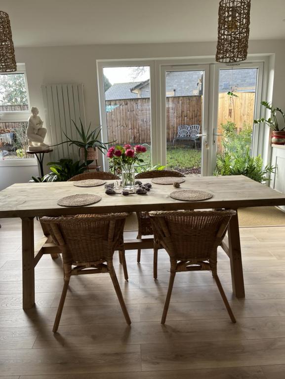 a large wooden table with chairs in a living room at Retreat for Two in Shepton Mallet