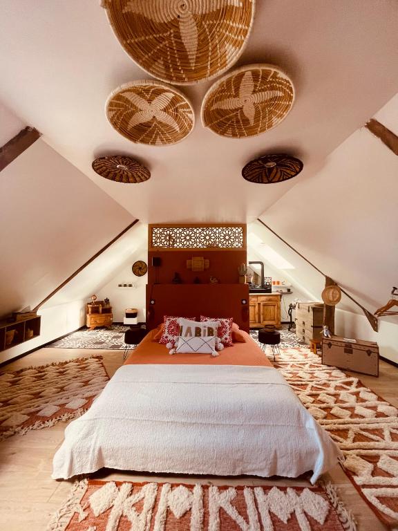 a bedroom with a large bed in a attic at Chez TROTRO in Saint-Pierre-de-Plesguen