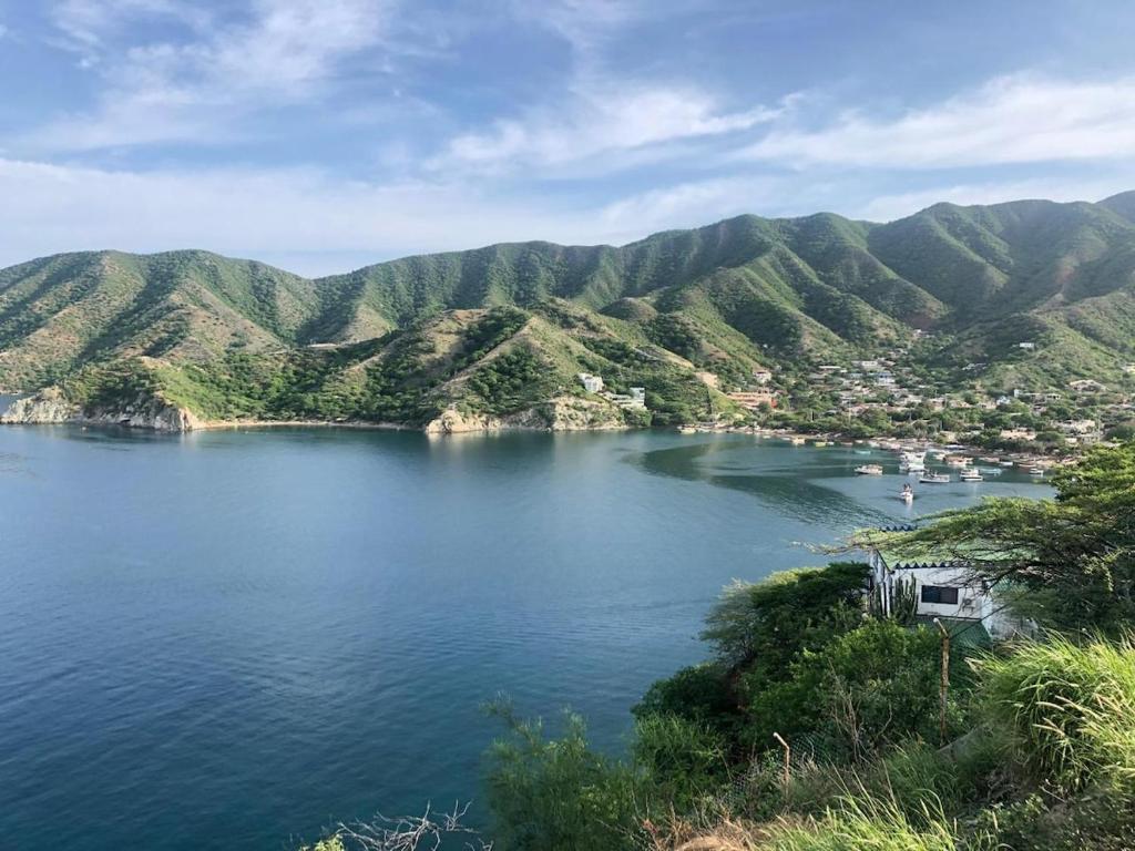 a view of a lake with mountains in the background at Cabañas Annapurna - Cabaña #12 in Taganga