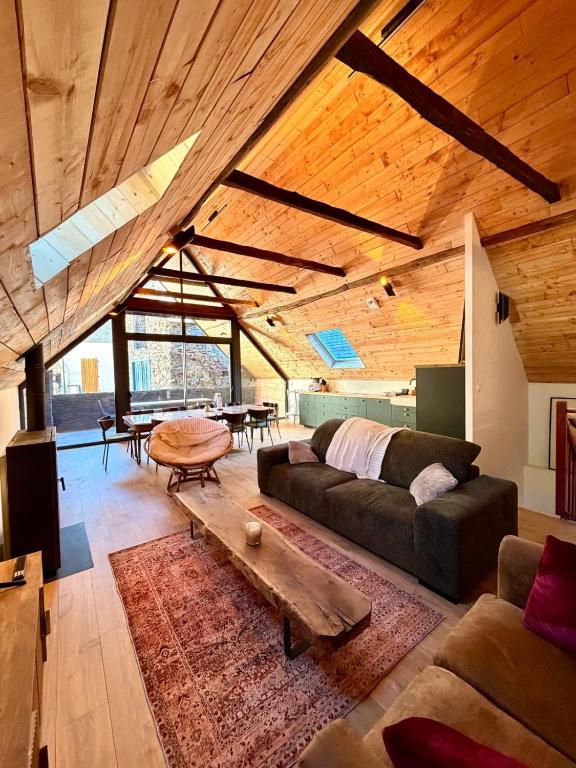 a living room with a couch and a table at La grange Ausar in Bareilles