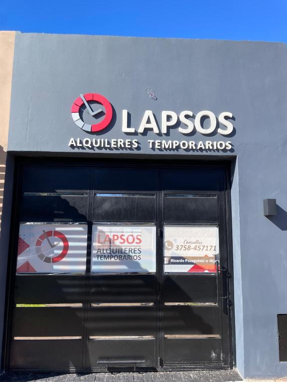 a garage door with a sign for a car dealership at Fully equipped studio apartments in Apóstoles