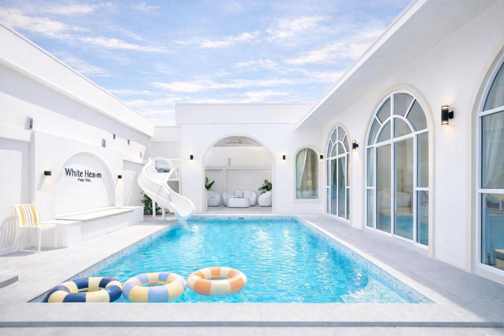 a swimming pool with balls in a house at White Heaven Pool Villa Pattaya in Ban Huai Yai