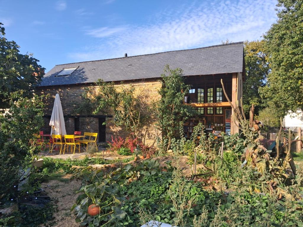 a house with a garden in front of it at Le Temps du Coeur - TYNID in Saint-Ganton