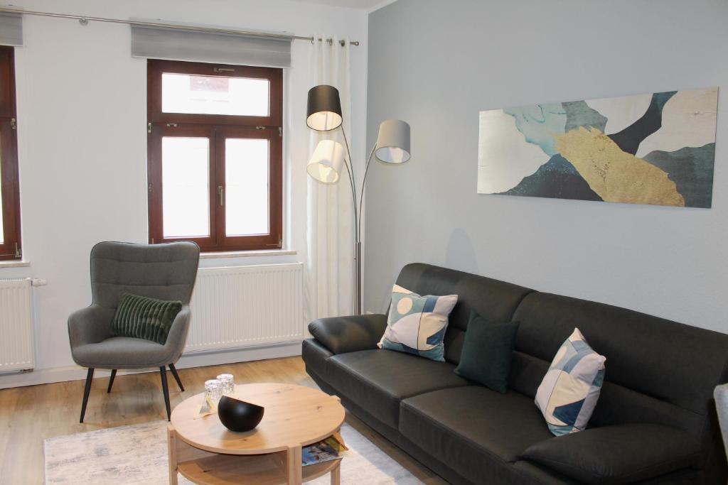 a living room with a couch and a chair at City-Appartement Pirna in Pirna