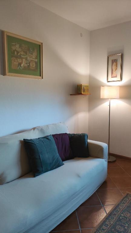 a white couch in a living room with a lamp at Casa Vallina - Garden & Mountain View in Castion
