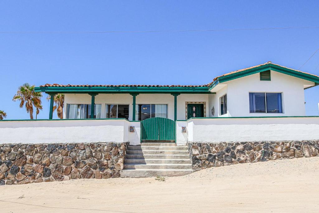 a house on the beach with a stone wall at Las Mareas #21 in Puerto Peñasco
