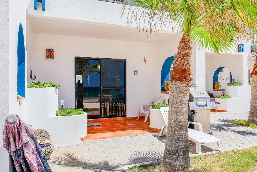 a palm tree in front of a house at Paradise Villas #16 in Playa Encanto