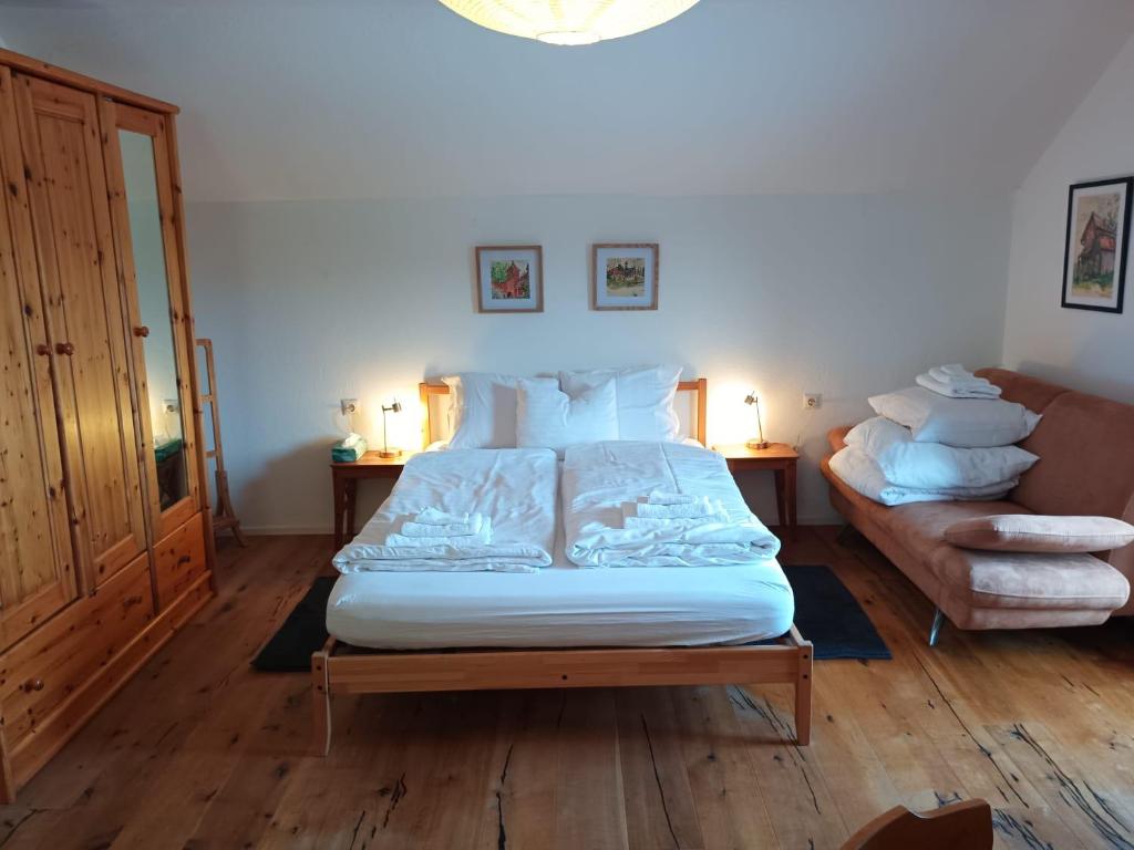 a bedroom with a large bed and a couch at Gästehaus Stolzalpe in Stolzalpe