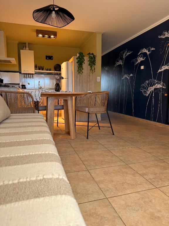 a kitchen and dining room with a table and chairs at Ginkgo Patagonia in El Bolsón