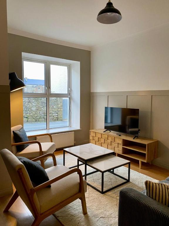 a living room with a couch and a coffee table at The Old Shop Apartment in Rathmullan