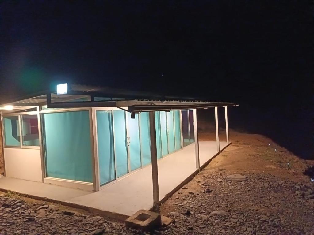 a building with a light on the roof at night at Cabaña - Macanal in Macanal