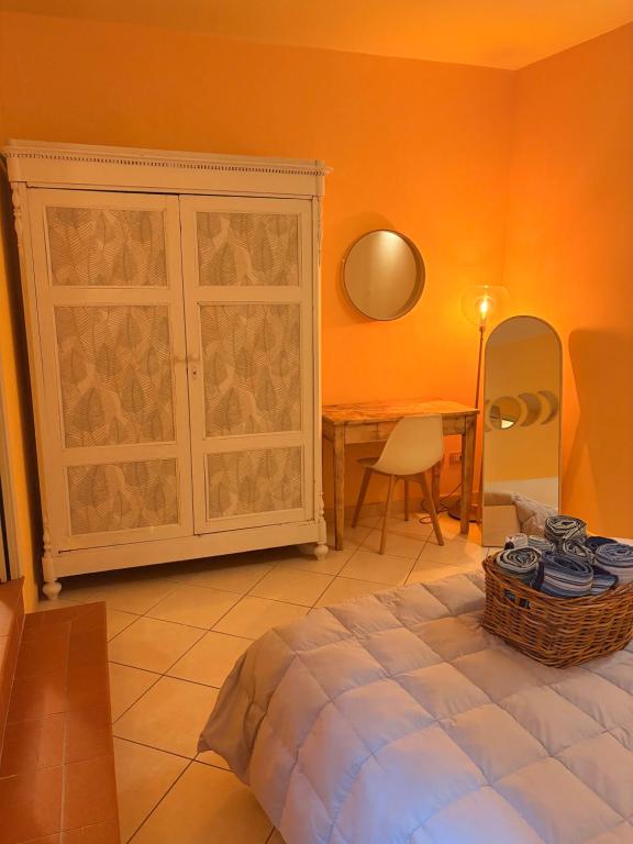 a bedroom with a bed and a table and a cabinet at Piazza Napoleone Sweet apartment in Lucca