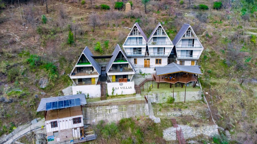 an aerial view of a large house on a hill at Raj Villas by Jomotel - A Riverside Retreat in Banjār