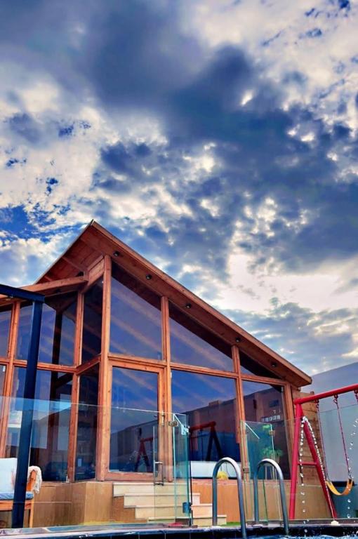 a building with a glass window and a playground at اكواخ اثينا الفندقية in Jeddah