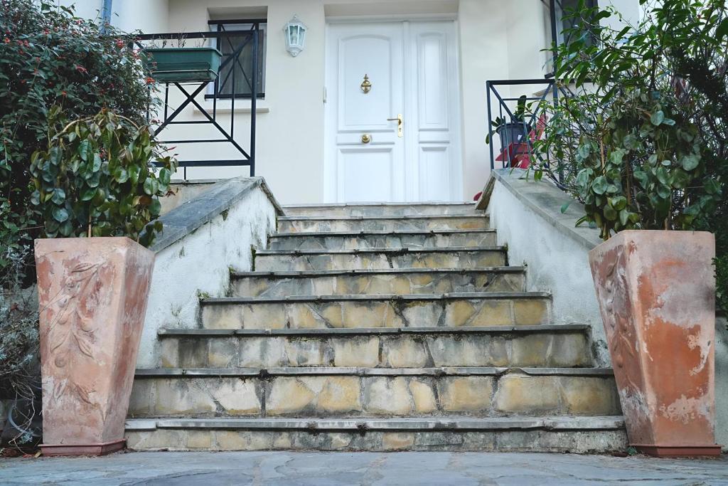 a set of stairs in front of a white door at Jolie chambre au centre Antony in Antony