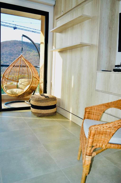 a room with a hammock and chairs and a window at Samaia Loft in Santa Marta