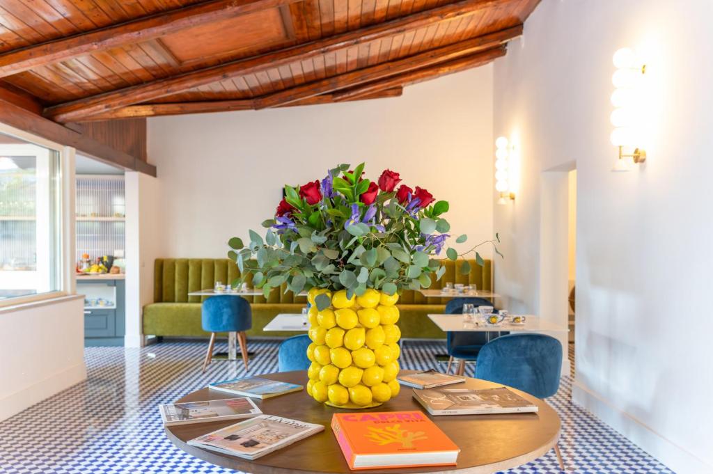 a vase of flowers on a table in a room at Villa Bellarosa in Sorrento
