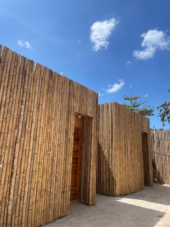 a wooden fence with a door in the middle at Homey Bamboo Lanta in Ban Ai Dao
