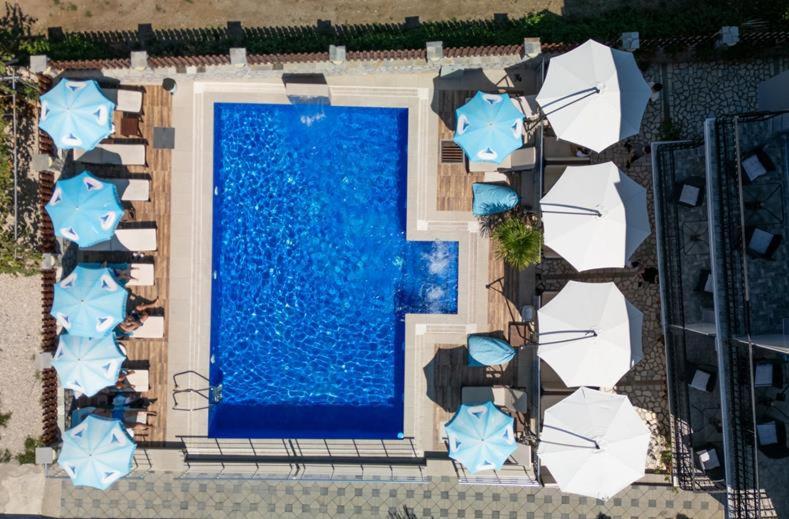 an overhead view of a swimming pool with umbrellas at Villa Mimi in Peštani