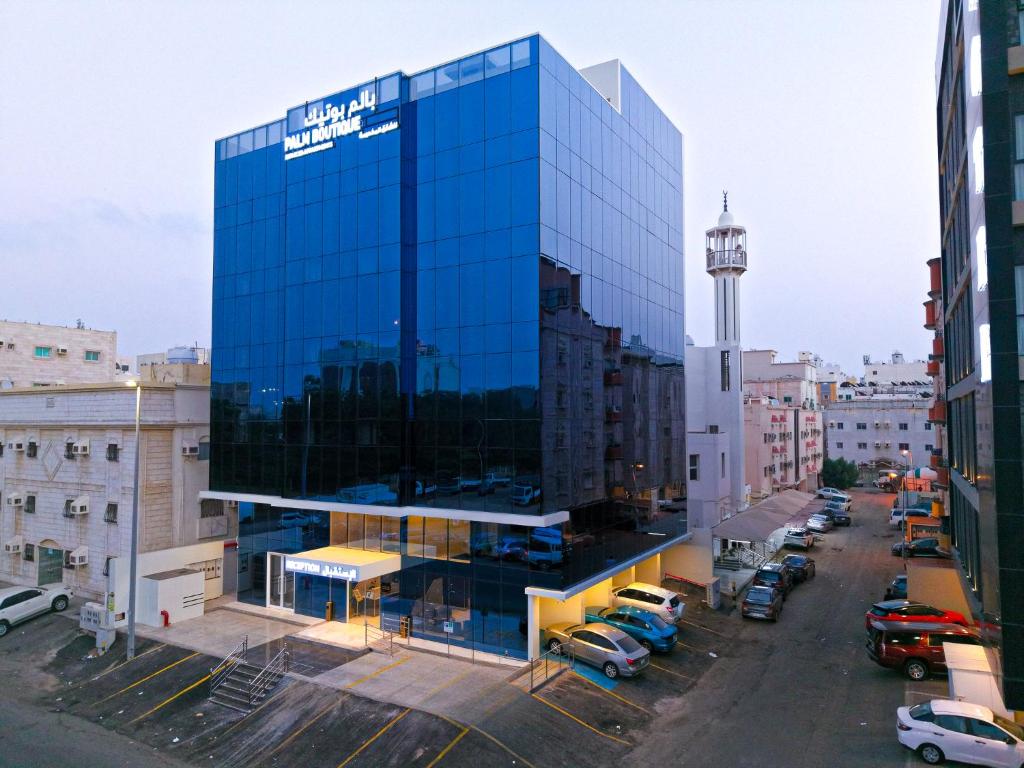 a glass building with a sign on the side of it at بالم بوتيك السلامه - Palm Boutique Alsalamah in Jeddah