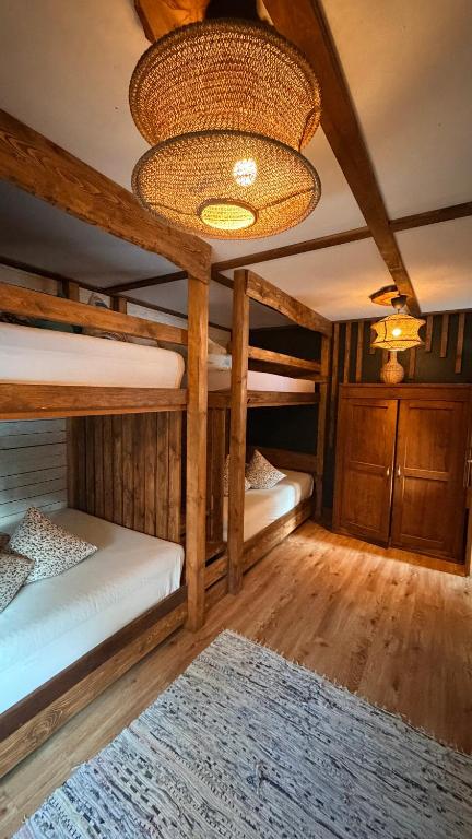 a room with two bunk beds and a ceiling at Camping Bušas in Saulkrasti