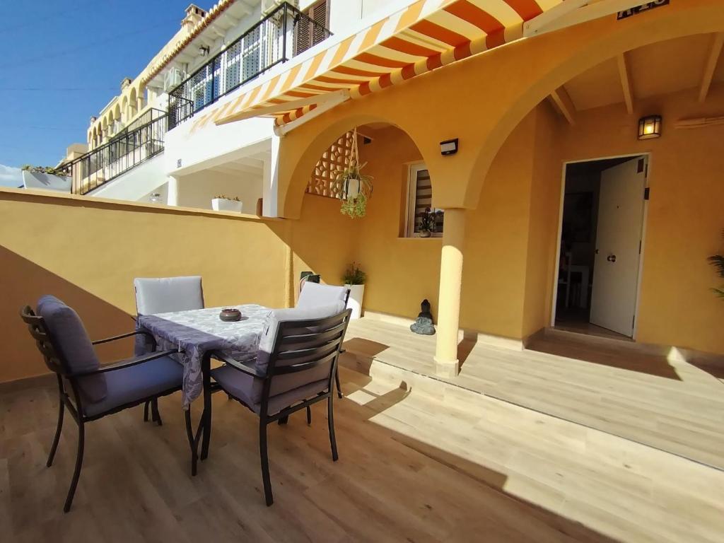a patio with a table and chairs on a balcony at Rosa de la Sal in La Mata