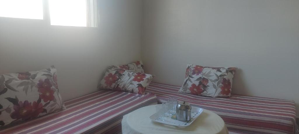 a small room with two chairs and a table at Appartement à Sable d'or tanger in Tangier