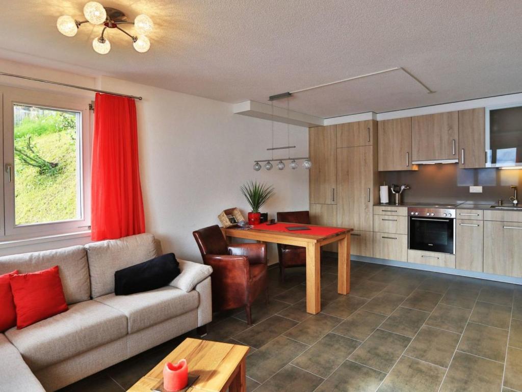 a living room with a couch and a table at Apartment Studio Flumserberg by Interhome in Flumserberg