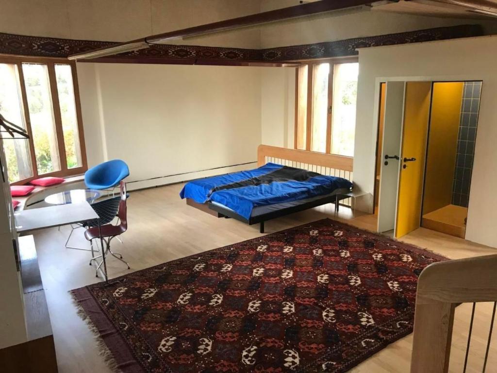 a bedroom with a bed and a table and a rug at Apartment sunehus-ch by Interhome in Stein